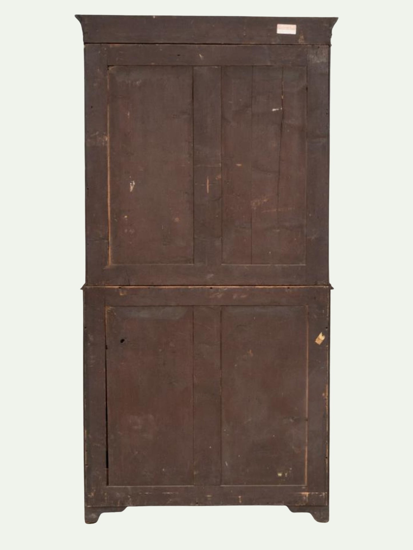 An antique wooden cabinet with two drawers on top and two doors below, featuring warm brown wood grain, decorative gold-toned metal drawer pulls, and light-colored inlay lines, set against a plain off-white background.