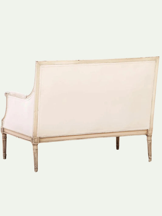 Beige upholstered bench with wooden frame on a white background