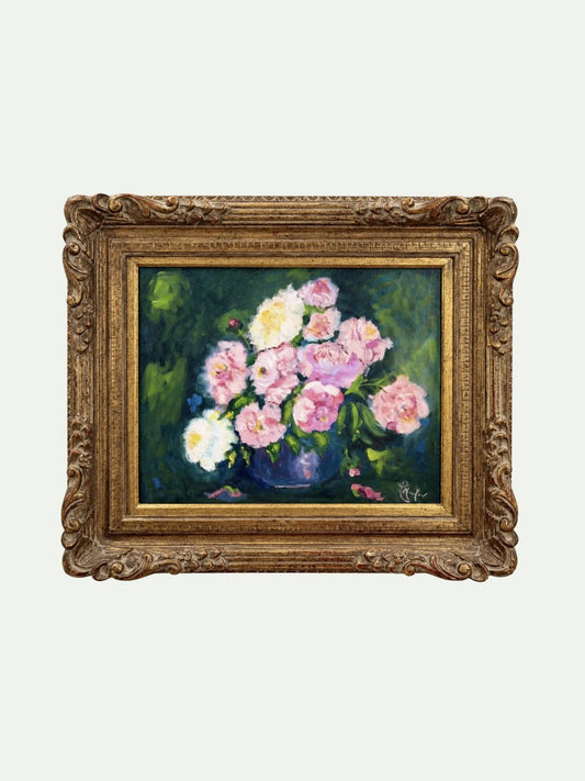 A framed oil painting of a bouquet of pink and white flowers in a dark green background, housed in an ornate gold frame, shown against a light gray background.