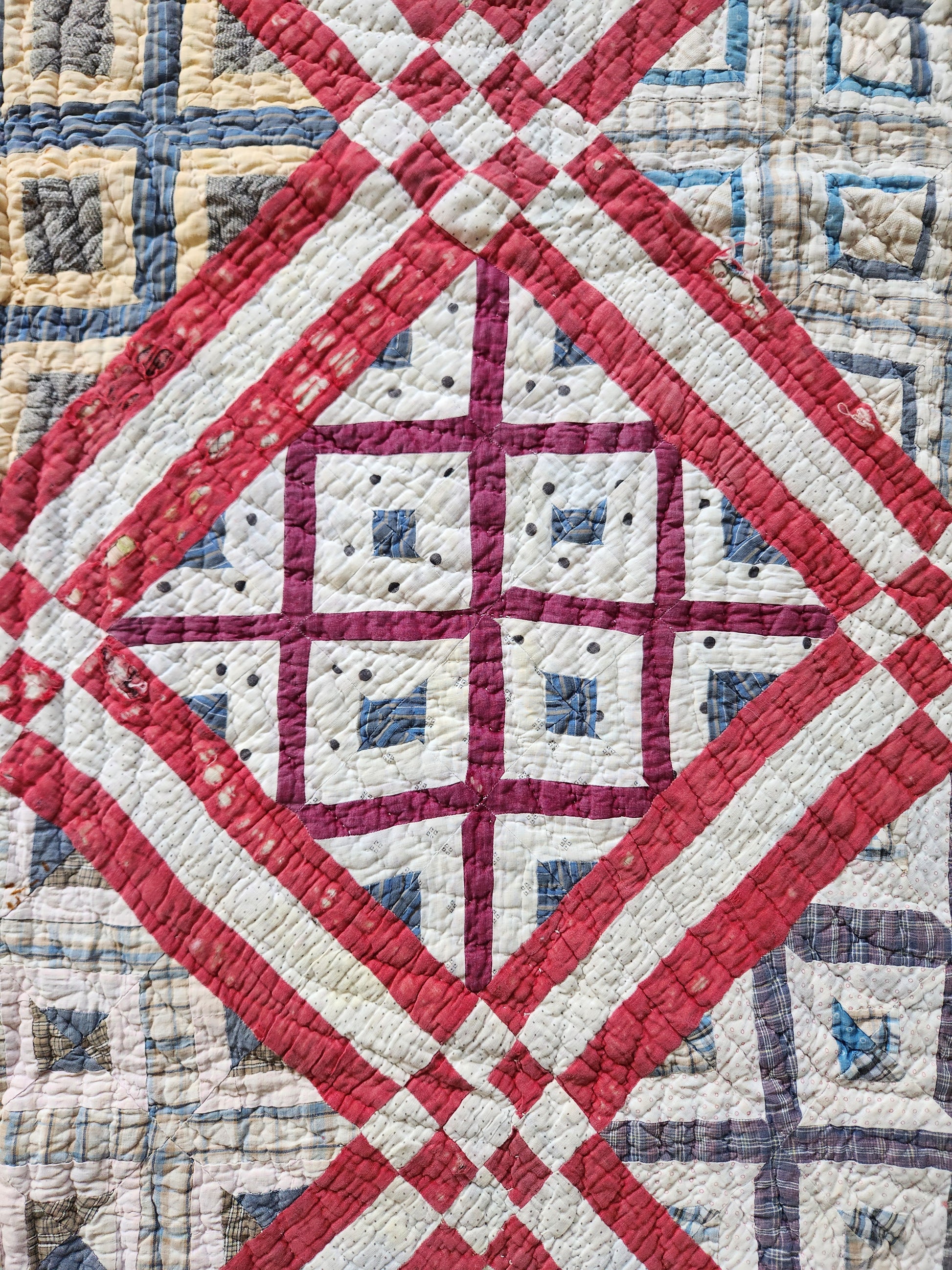 Quilt with red, white, and blue geometric pattern