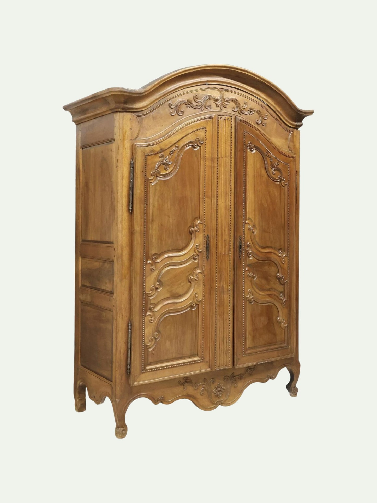 An ornate vintage-style wooden armoire cabinet with carved details, shown against a plain light background.