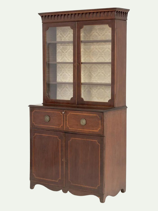 A vintage dark brown wooden hutch cabinet with a glass-front upper display cabinet, two drawers with round brass knobs, and two lower cabinet doors with decorative gold-toned inlay, shown against a plain off-white background.