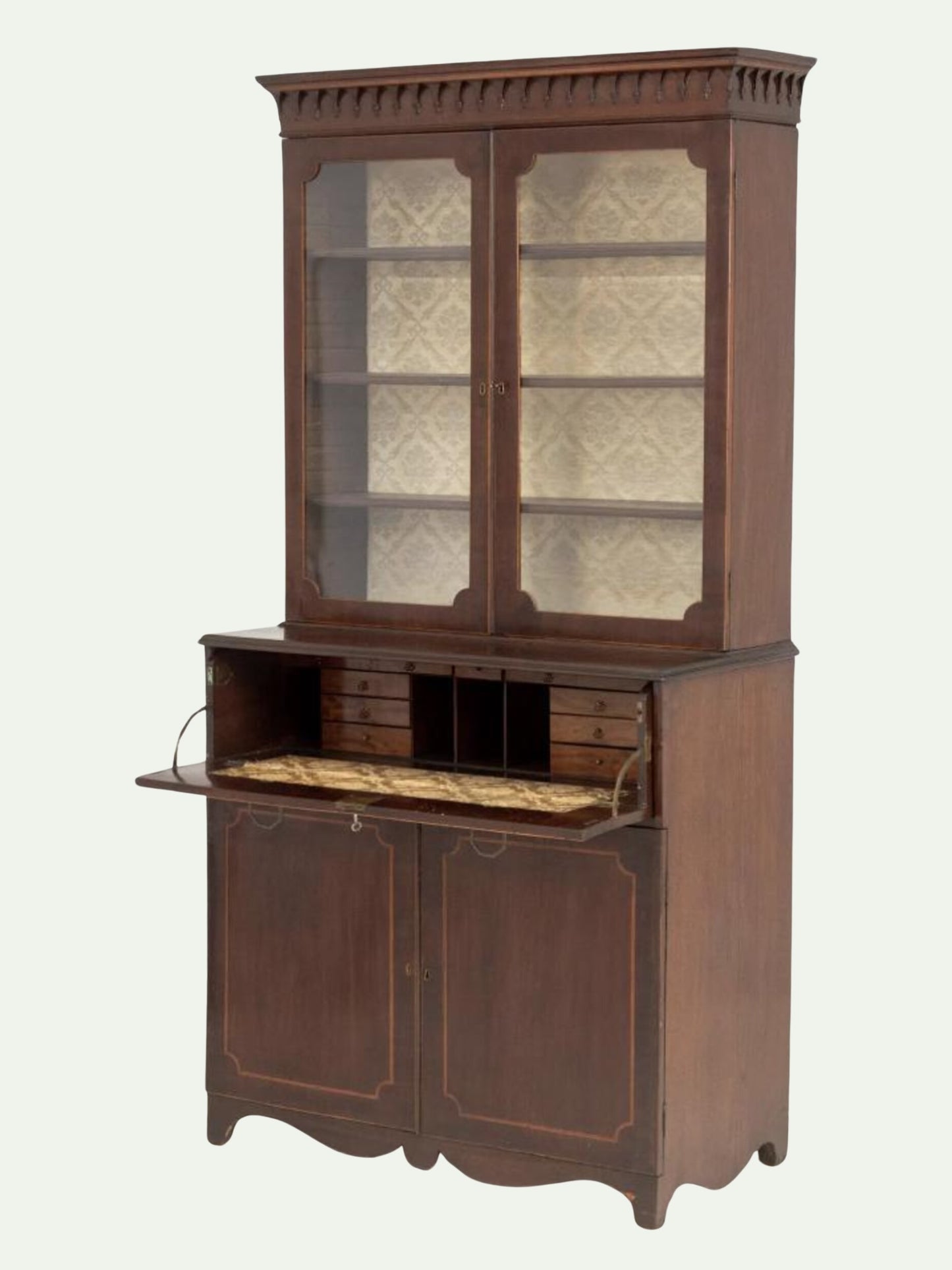 An antique dark brown wooden secretary desk with a glass-front upper cabinet, pull-out writing desk surface, and decorative paneling, shown against a plain light background.