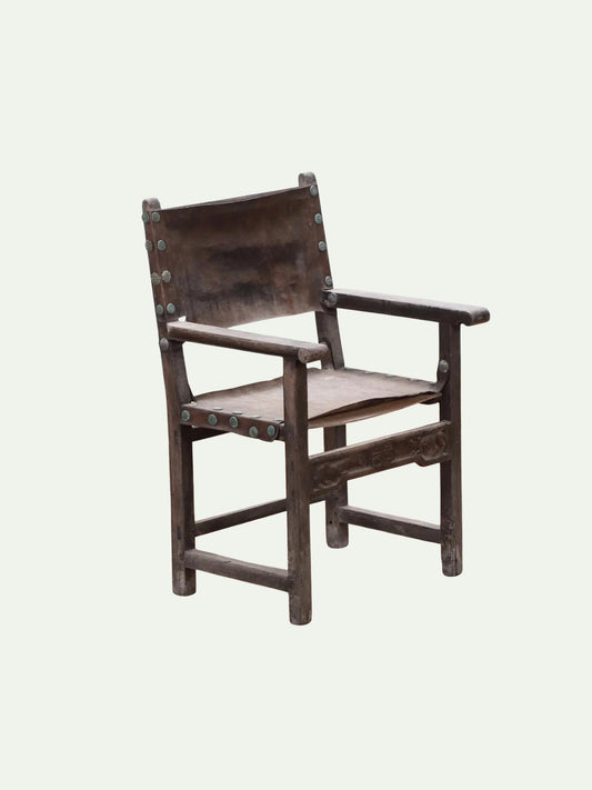 Wooden chair with woven seat on a light gray background