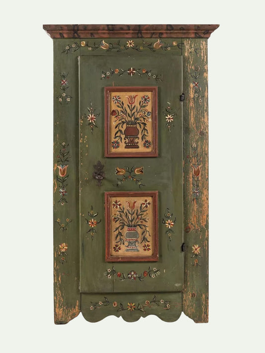 An antique green wooden cabinet with hand-painted floral motifs and two central floral panels, shown against a plain light background.