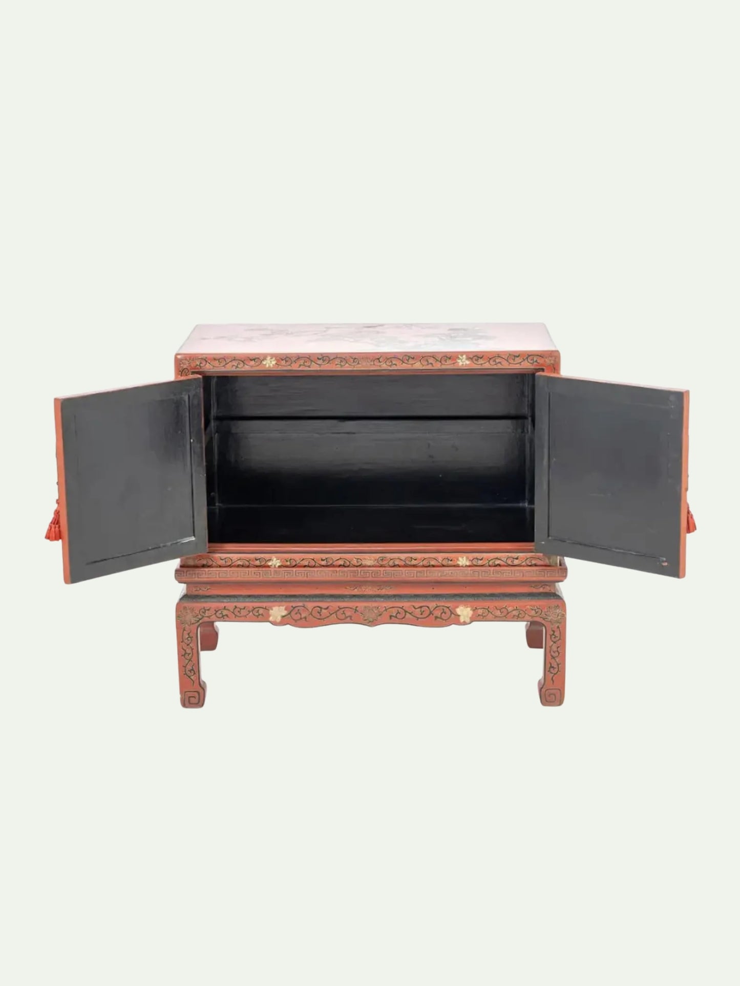 A traditional Chinese lacquered cabinet with two open doors, showcasing a black interior, set against a solid off-white background.