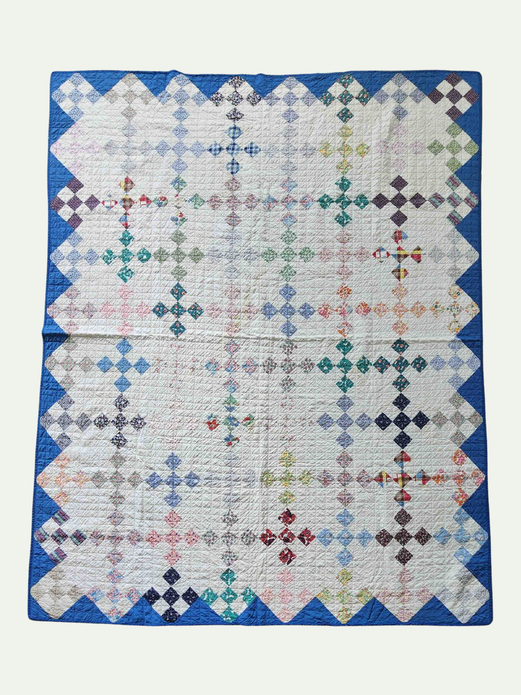 Quilt with geometric pattern on a white background