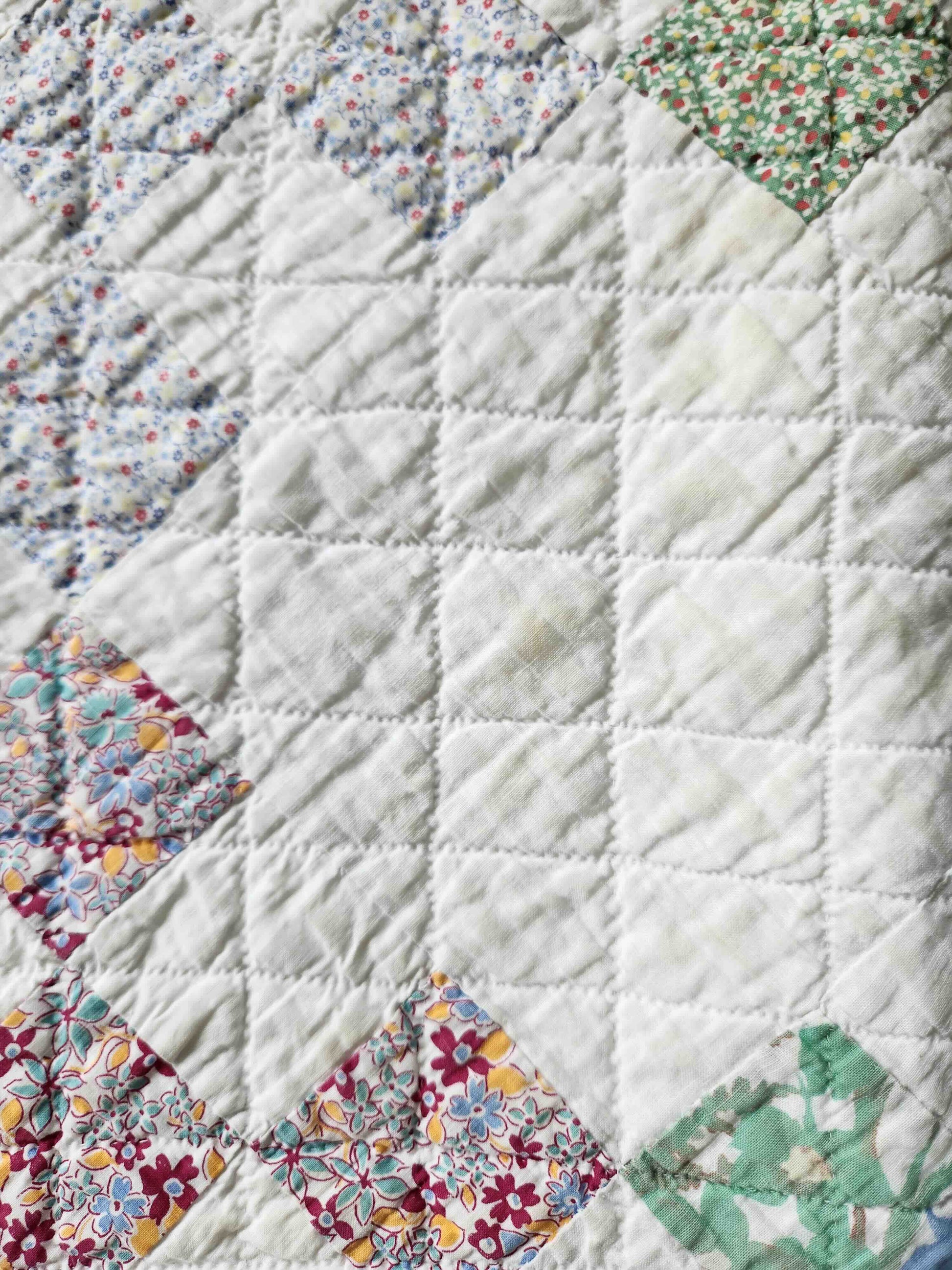 Quilt with floral patchwork design on a white background
