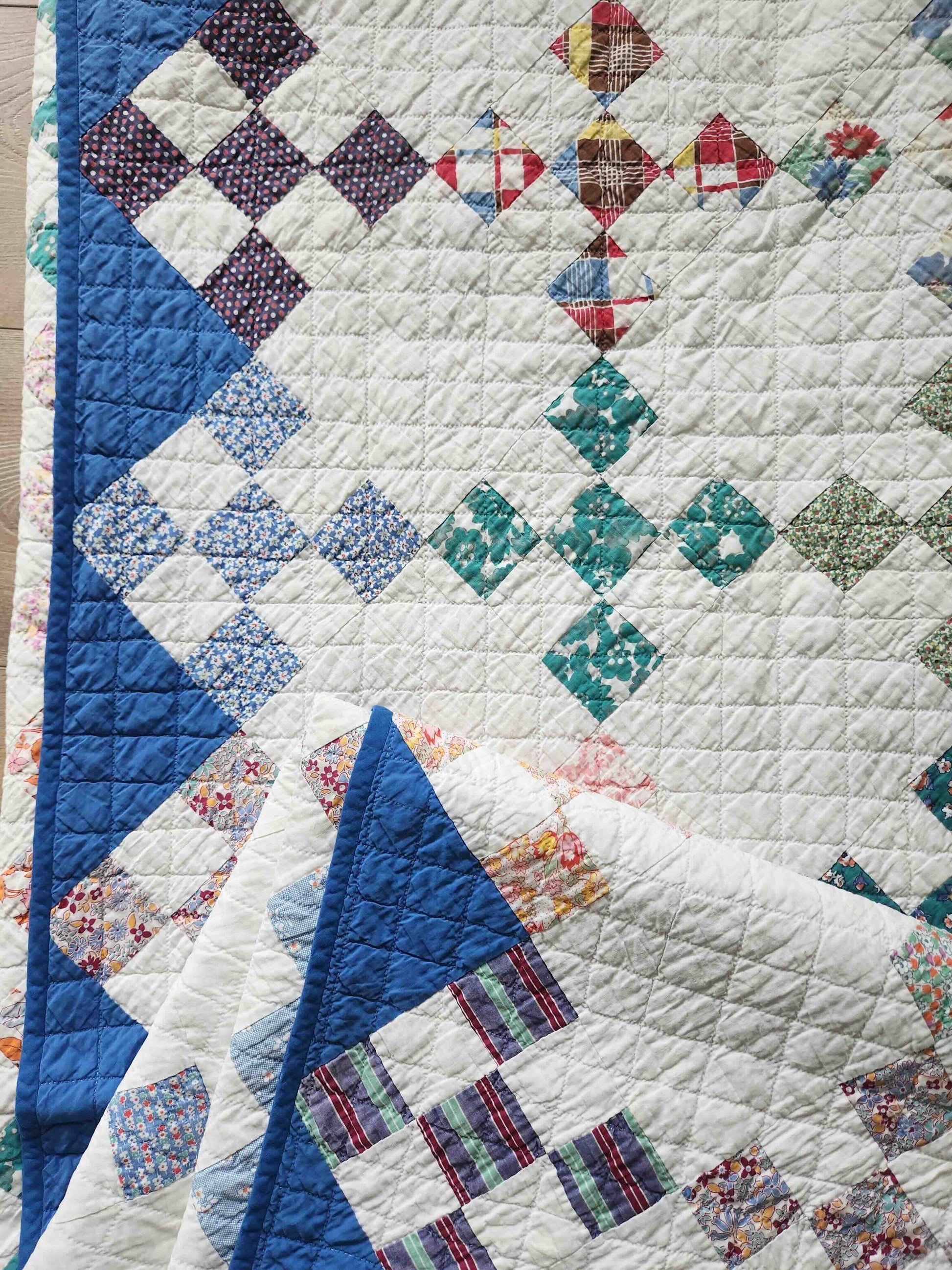 Colorful quilt with geometric patterns on a wooden surface