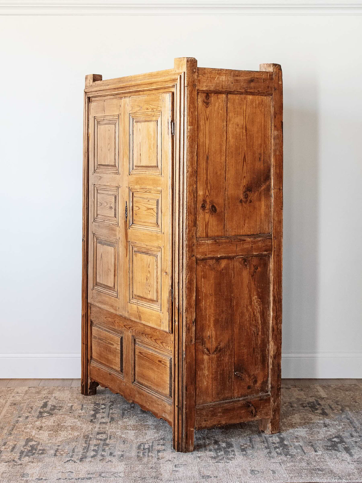side profile antique European country pine armoire with paneled doors lift top storage