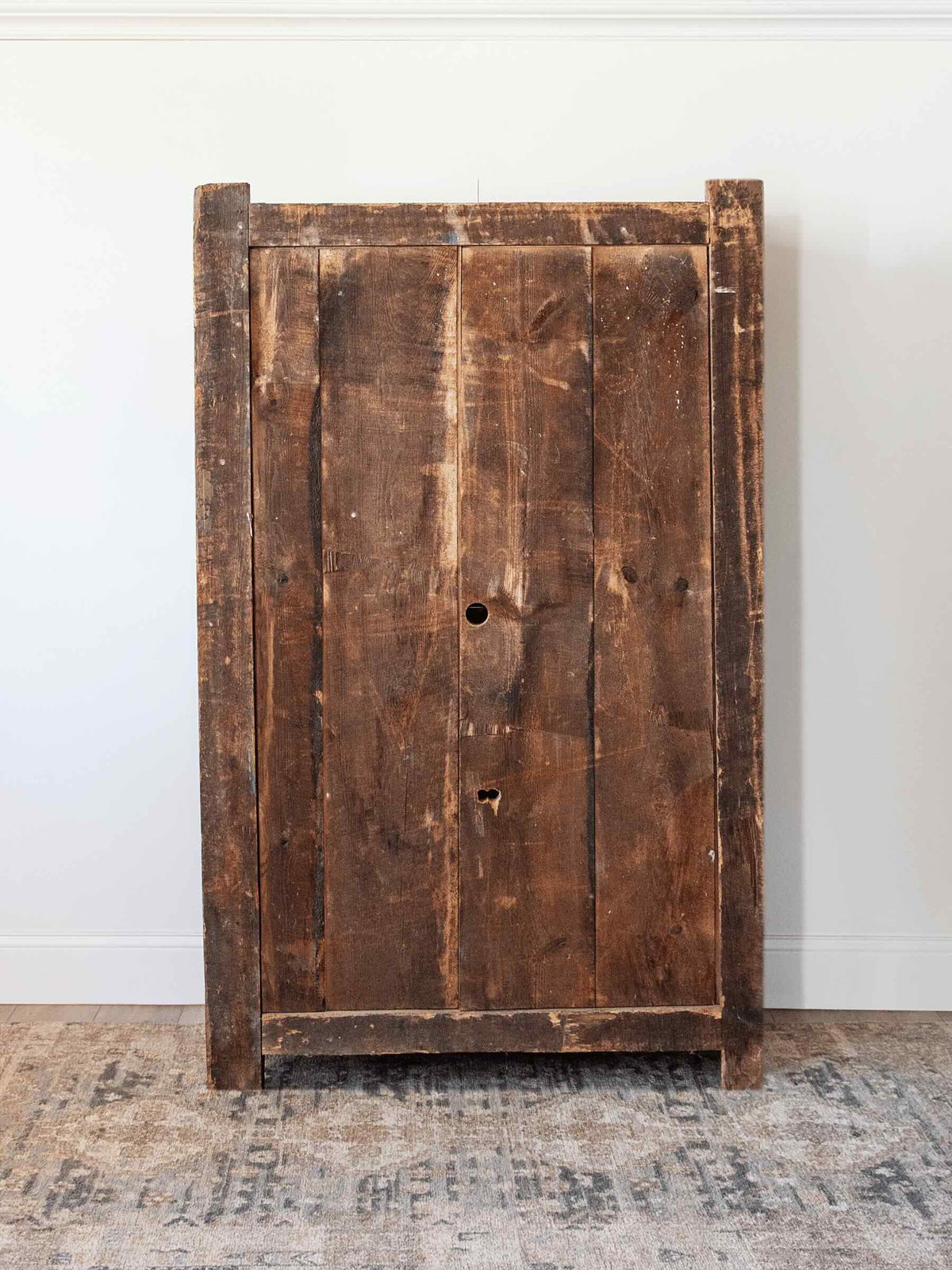 back of antique European country pine armoire with paneled doors lift top storage