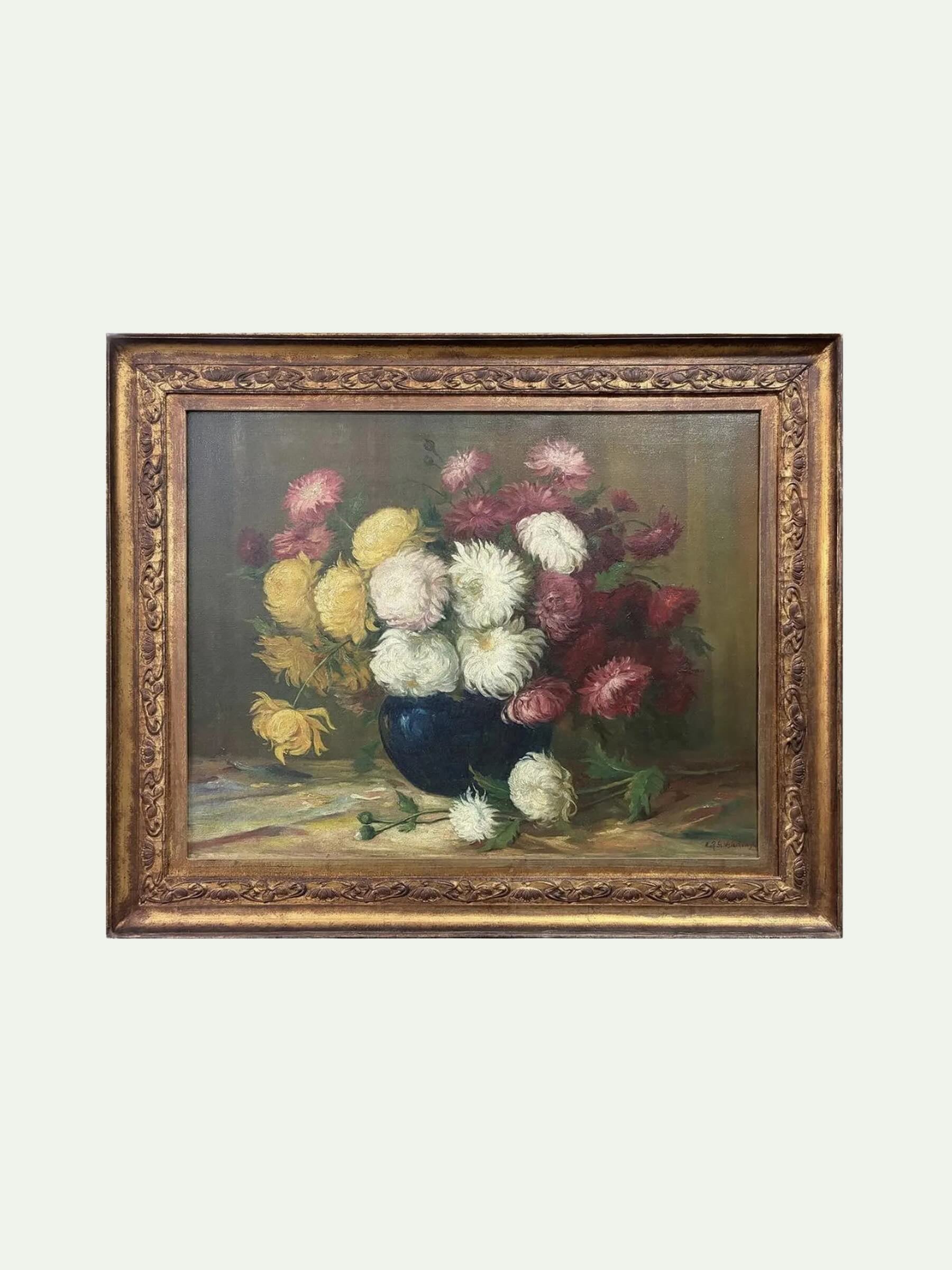 A framed still life oil painting featuring a bouquet of pink, yellow, and white flowers in a dark blue vase, enclosed in an ornate gold frame against a light gray background.