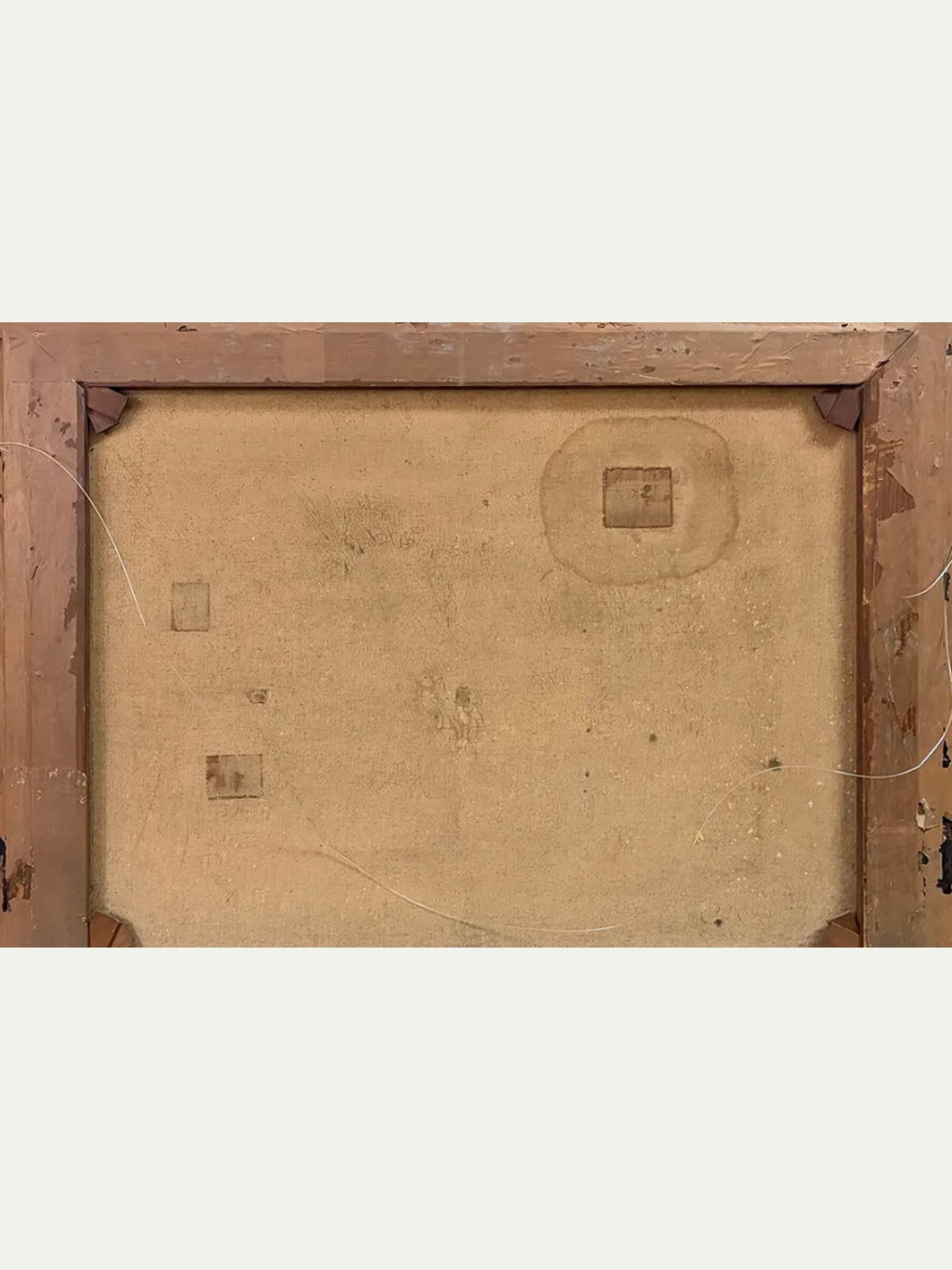 The back of a framed artwork showing a square wooden frame with a tan canvas or board backing, corner brackets, and visible wire details against a light gray background.