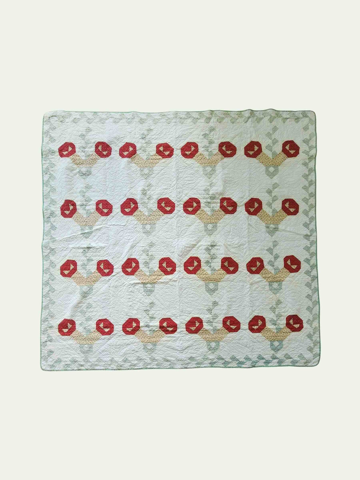 Quilt with red floral pattern on a white background
