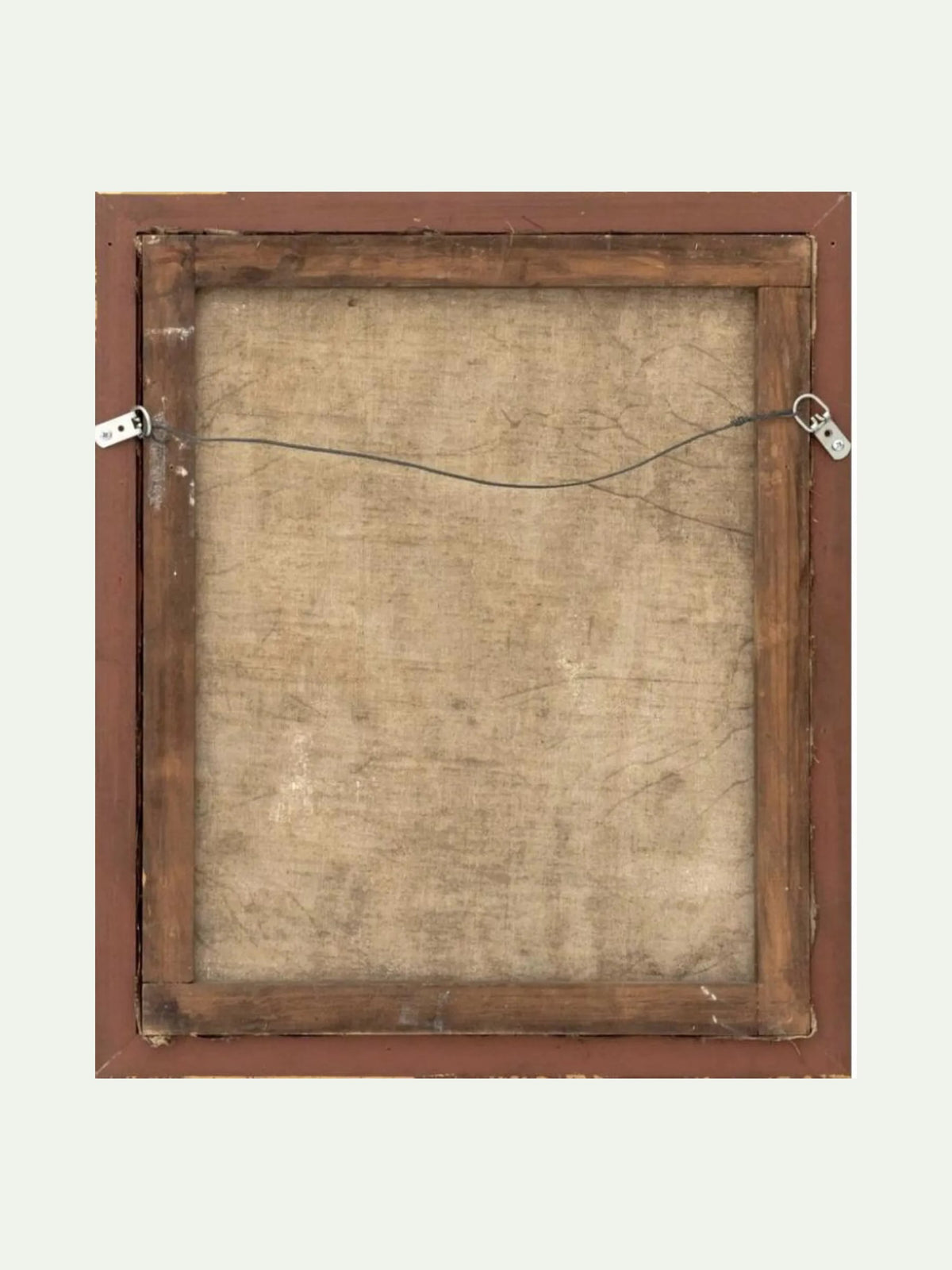The back of a square framed artwork, showing a brown wooden frame, canvas backing, hanging wire, and metal clips against a light off-white background.