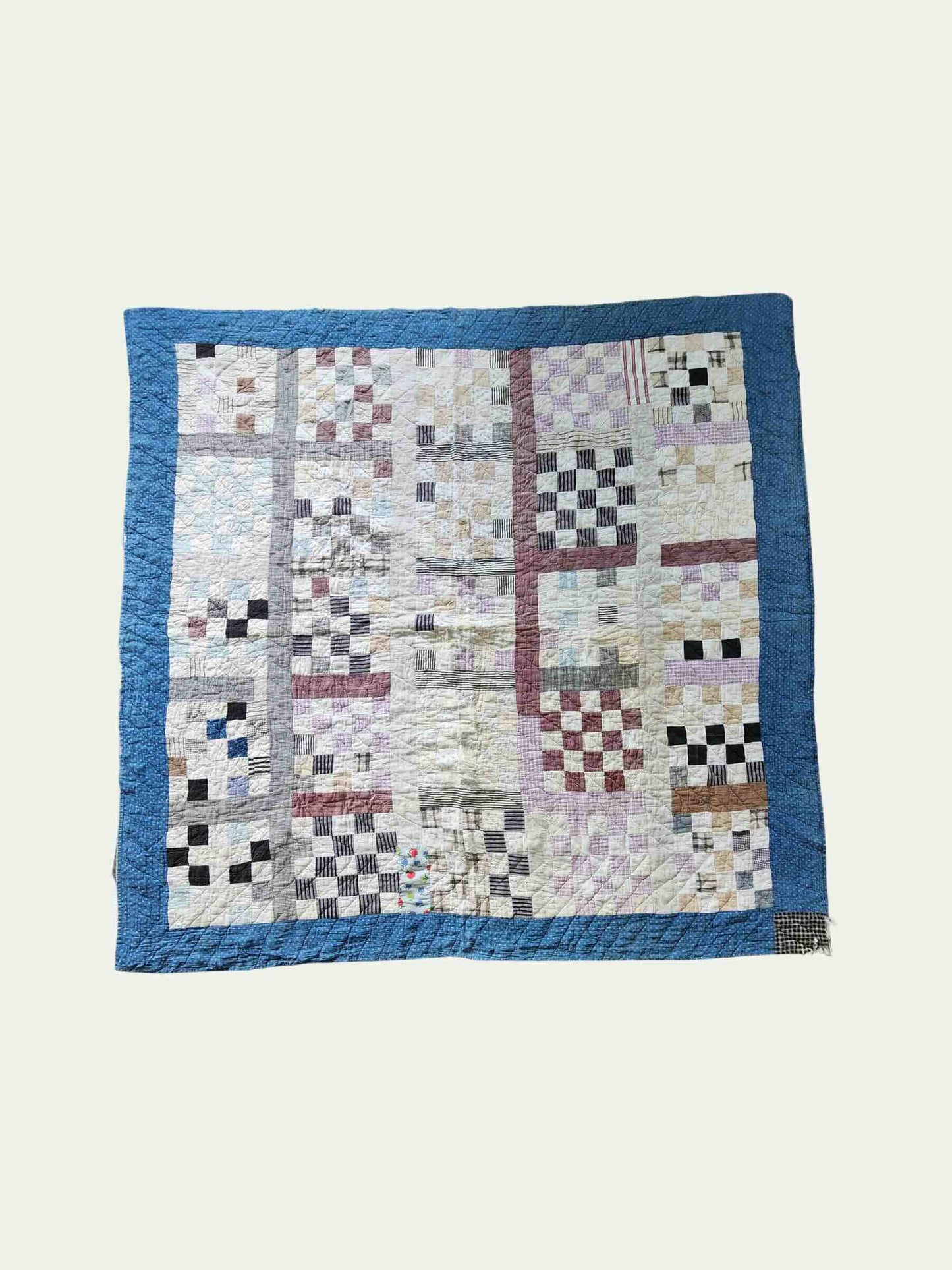 Quilt with geometric patterns on a white background