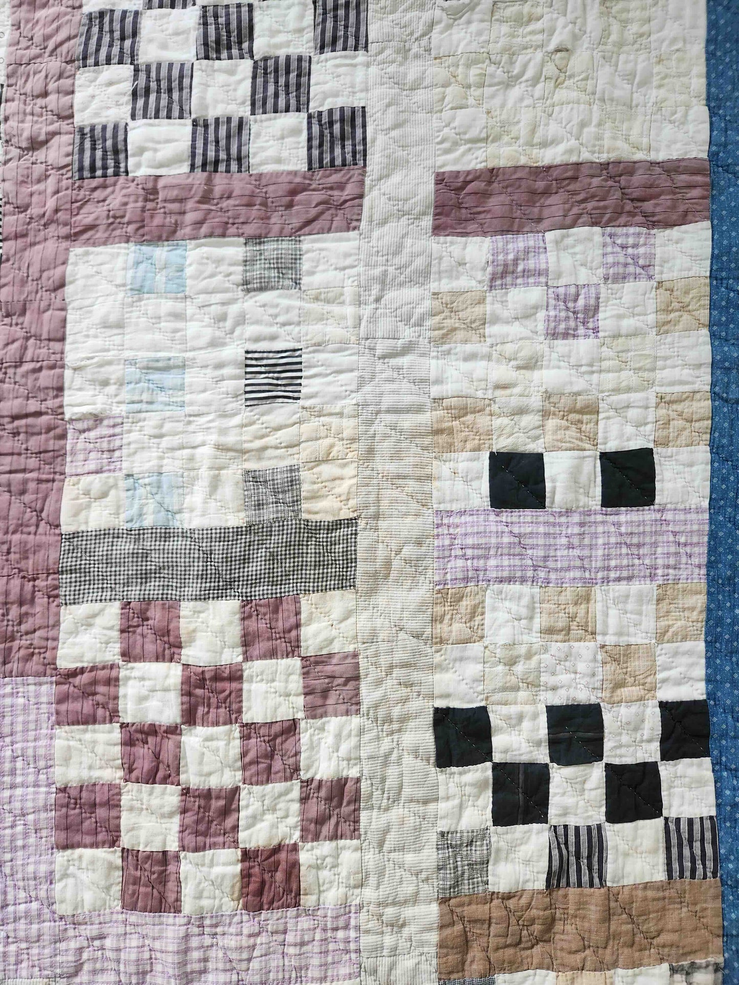 Patchwork quilt with a checkered pattern featuring various colors.