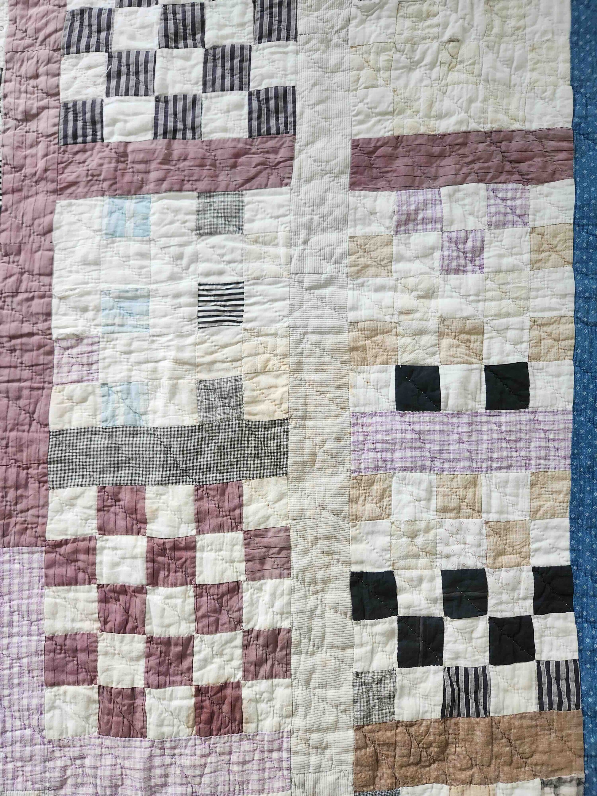 Patchwork quilt with a checkered pattern featuring various colors.