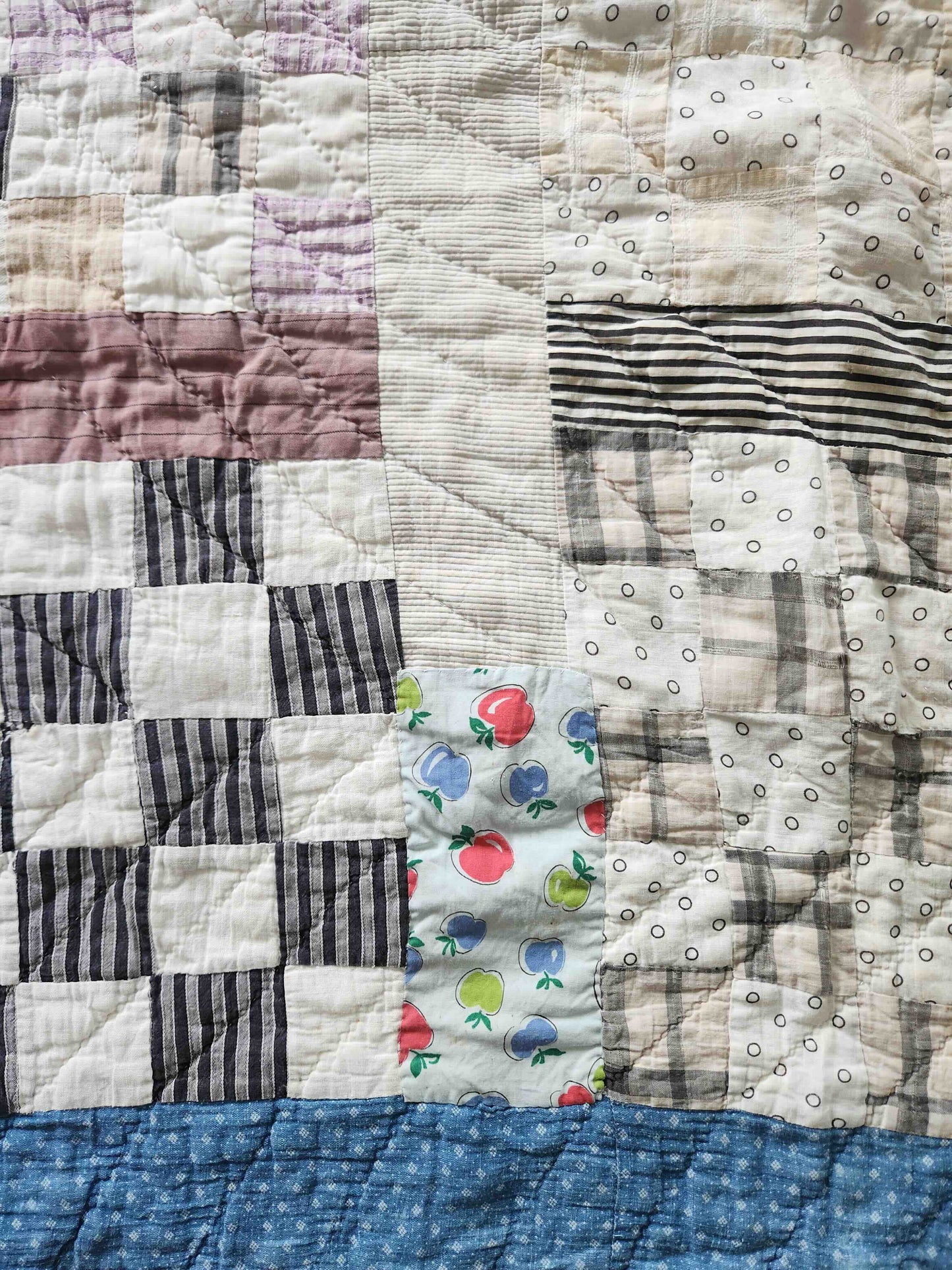 Patchwork quilt with floral pattern in the center