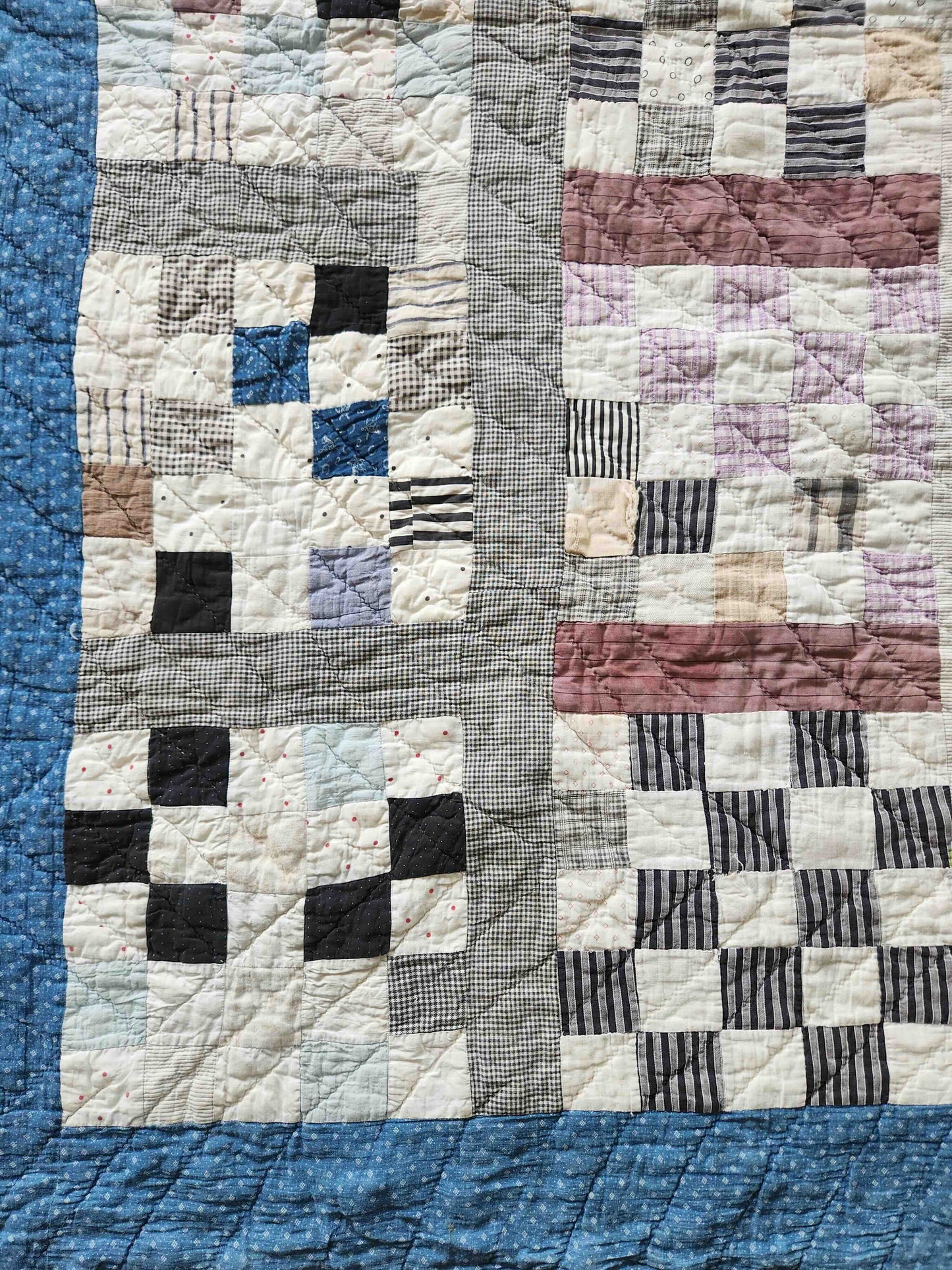 Patchwork quilt with a geometric pattern on a blue background