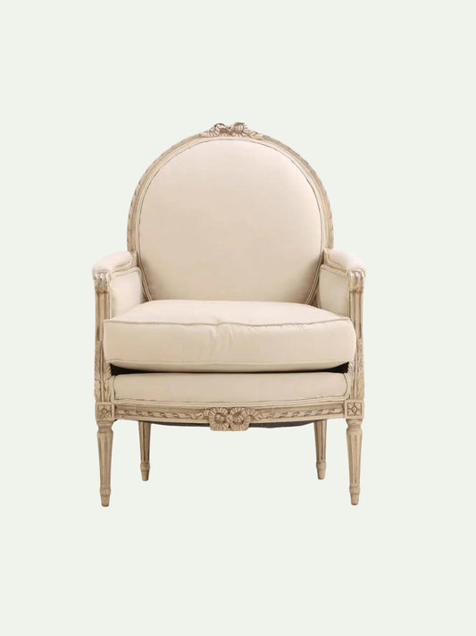 Beige armchair with decorative wooden frame on a white background