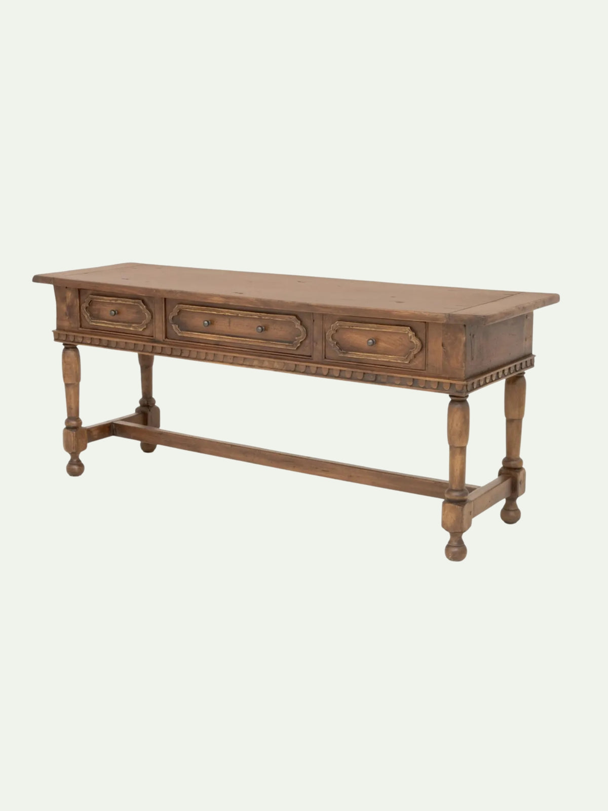 A rustic three-drawer wooden console table with turned legs and a lower stretchers bar, shown against a plain off-white background.