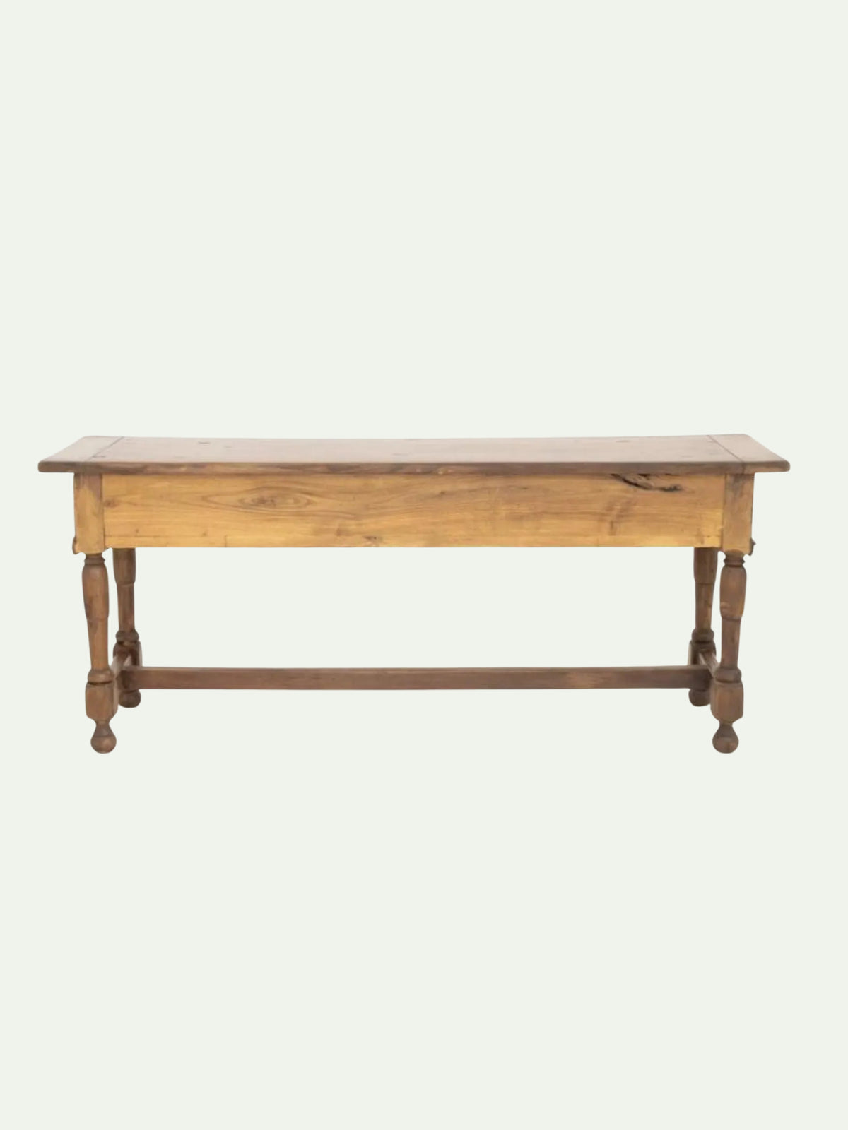 A rustic wooden coffee table with a light oak top, turned legs, and a dark brown stretcher bar, shown against a plain off-white background.