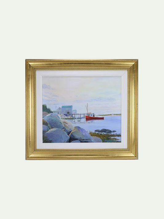 A framed landscape painting depicting a calm harbor scene with blue-gray rocks, a small red boat, and a pale sky, presented in a gold frame with a white mat against a light gray background.