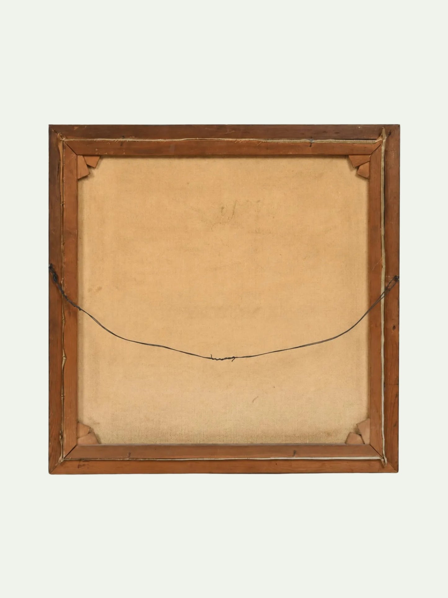 The back of a square wooden picture frame with a tan linen backing and a black hanging wire, shown against a light off-white background.