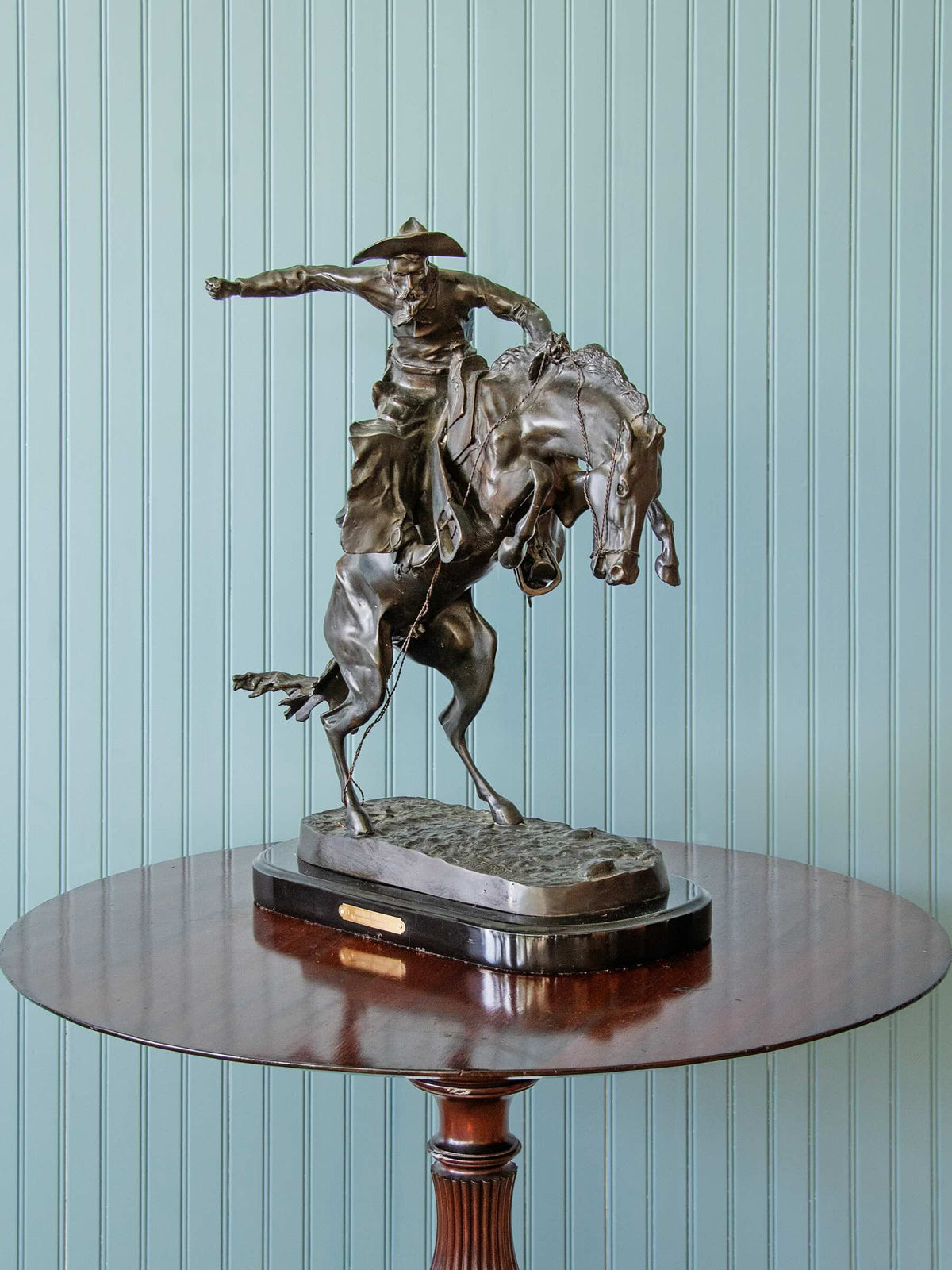 bronze statue of a cowboy riding a horse