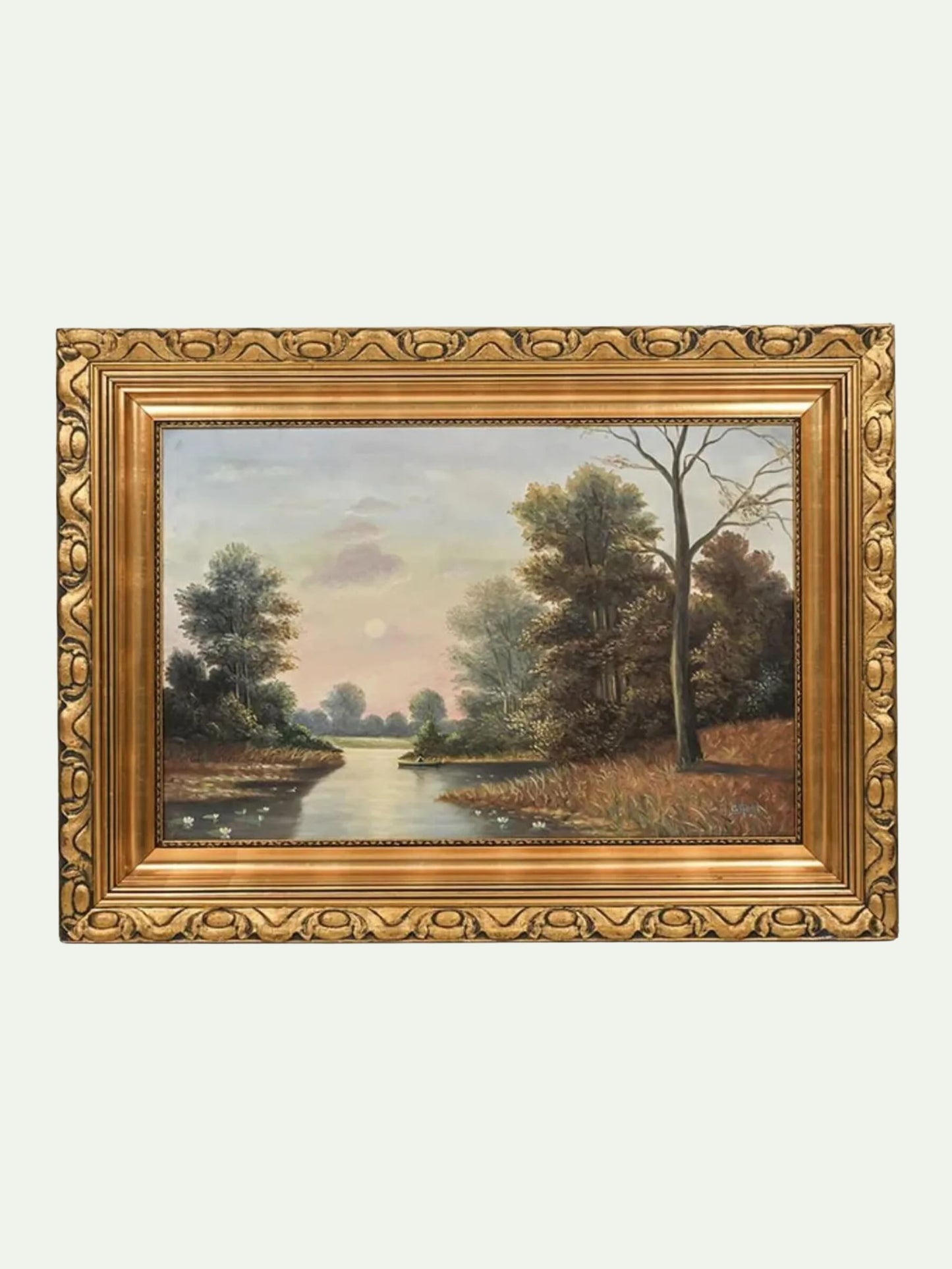 A framed landscape oil painting featuring a river or canal winding through a wooded area under a soft sky, enclosed in an ornate gold frame against a light gray background.