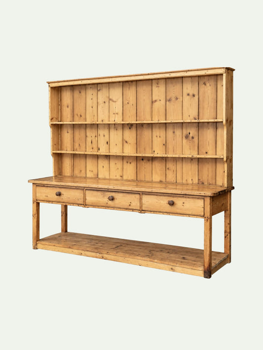 A rustic pine wood hutch with three open shelves on the upper section, three drawers with round knobs on the middle, and a lower open shelf, shown against a light off-white background.