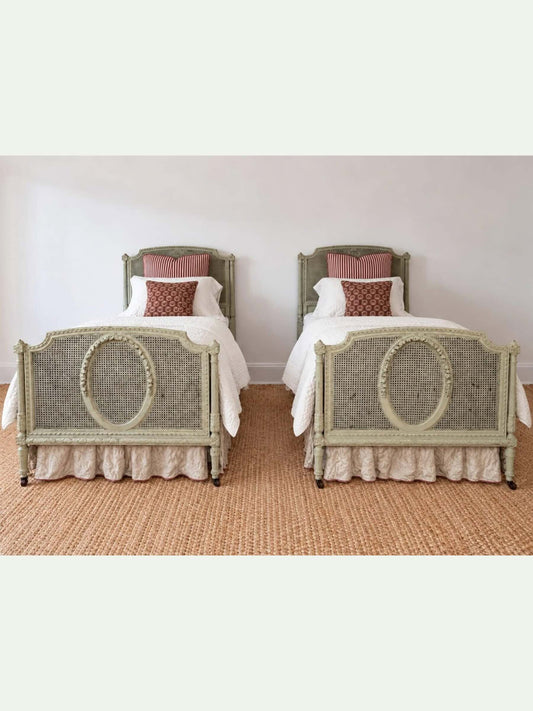Pair of Antique French Louis XVI–Style Painted Cane Twin Beds with Carved Floral Medallions | 1900
