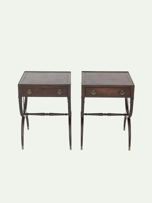 A pair of dark brown wooden nightstands with single drawers, brass ring pulls, and turned legs, shown against a light off-white background.