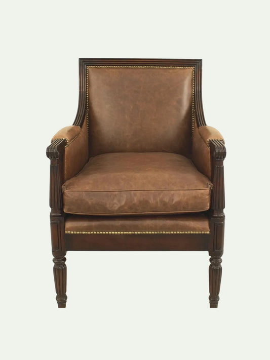Brown leather armchair with wooden frame on a white background