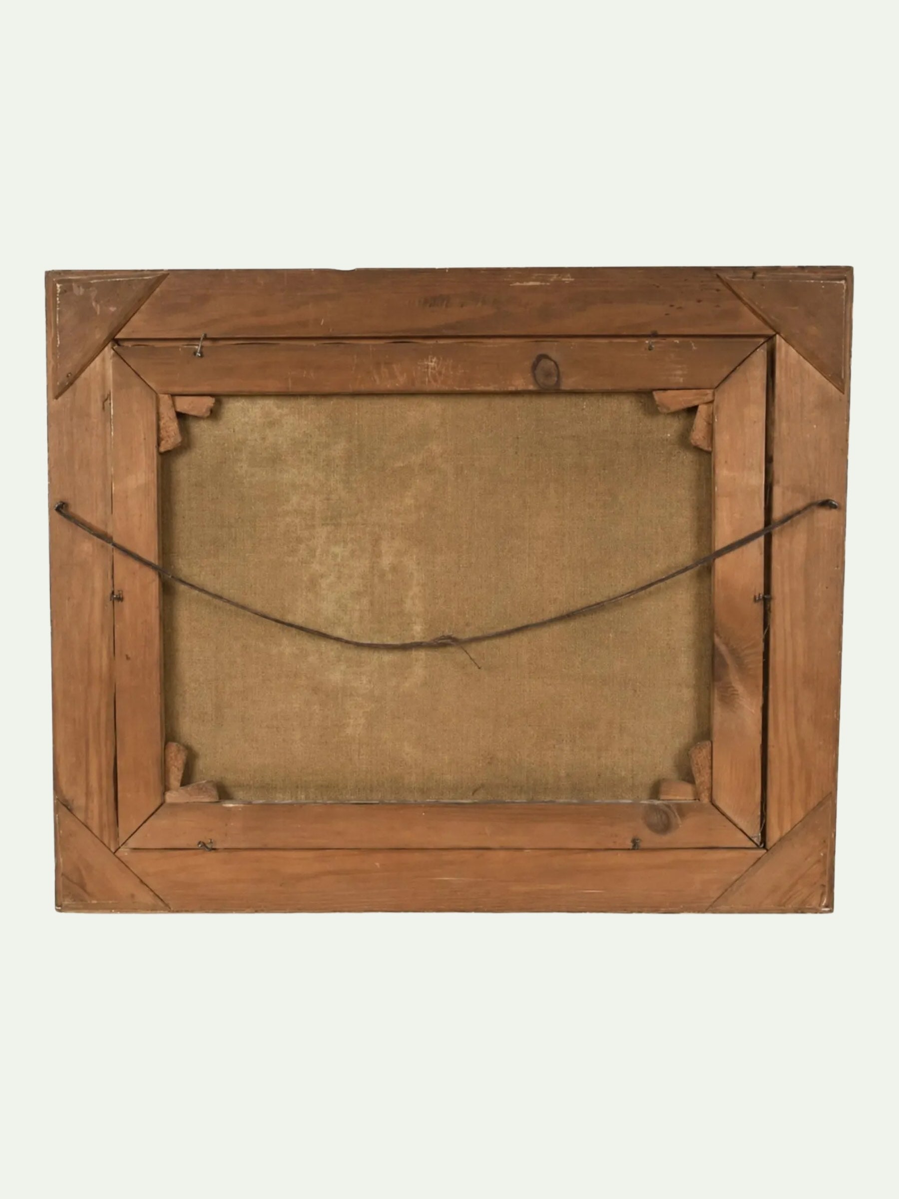 The back view of a square wooden picture frame, showing the natural wood grain, corner brackets, and hanging wire against a light off-white background.
