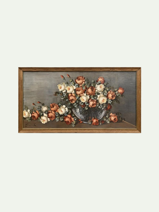 A framed still life painting featuring a bouquet of peach, cream, and white flowers in a blue-gray vase against a muted gray background, enclosed in a warm brown wooden frame.