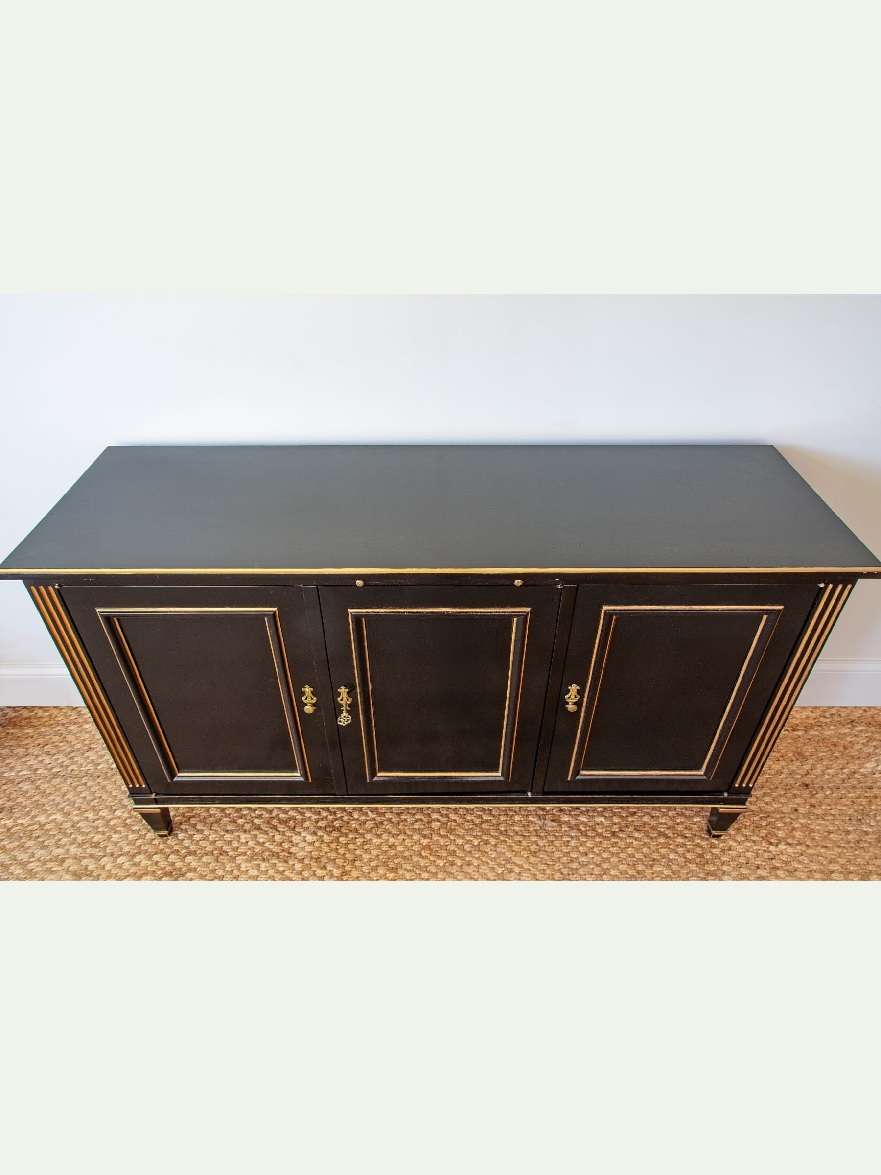 Black cabinet with gold accents on a white background